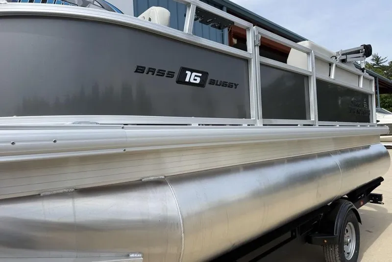 Slide: The Image of 2026 Sun Tracker Bass Buggy 16 XL Select pontoon boat on trailer. - 4