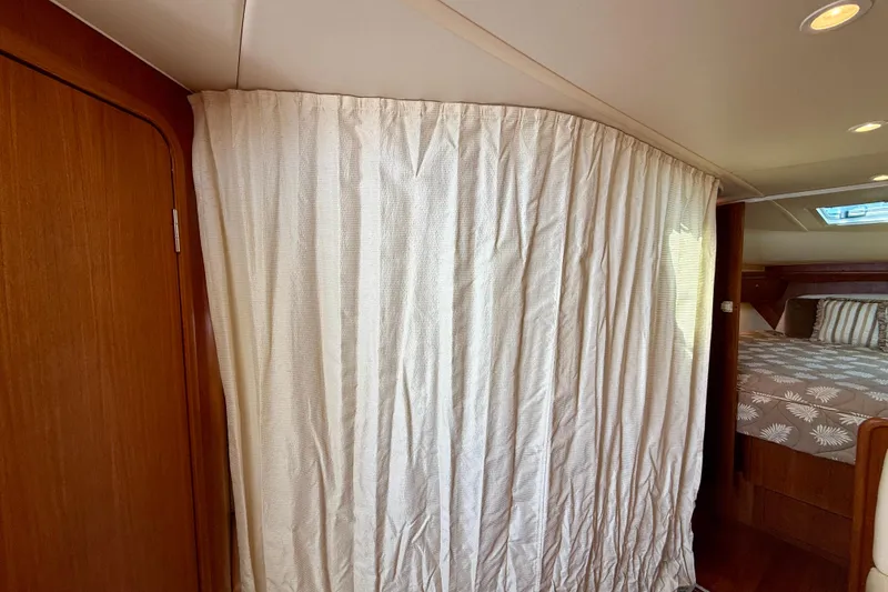 Slide: The Image of Interior of 2006 Tiara Yachts 3600 Sovran with curtain and cozy bed area. - 11