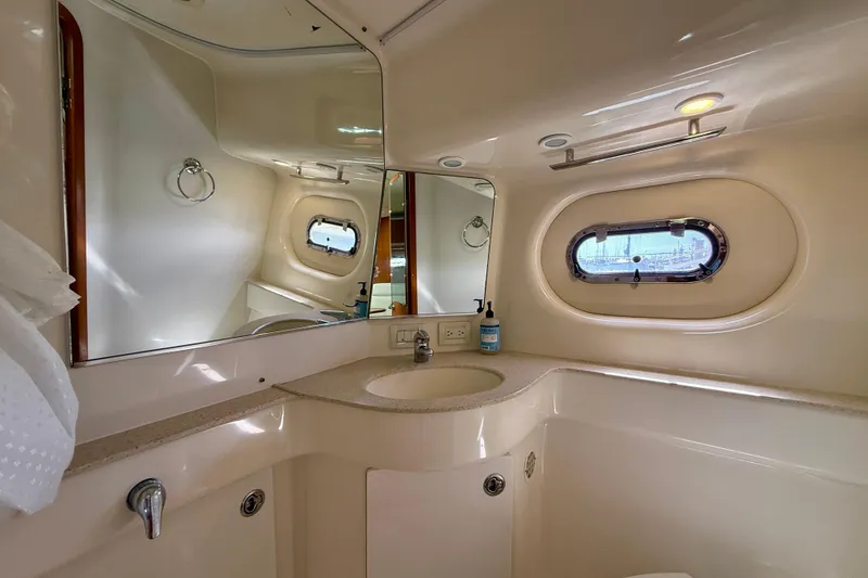 Slide: The Image of Luxurious bathroom interior of 2006 Tiara Yachts 3600 Sovran with elegant fixtures and porthole window. - 12