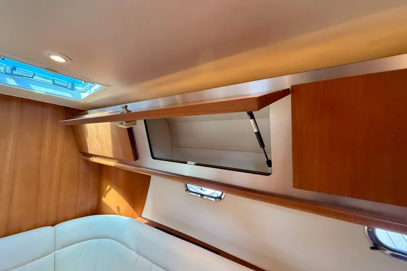 Slide: The Image of Interior of 2006 Tiara Yachts 3600 Sovran with open wooden cabinet and seating. - 15