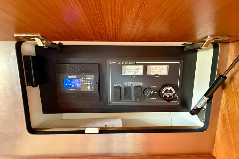Slide: The Image of Electrical control panel of a 2006 Tiara Yachts 3600 Sovran, featuring volt and amp meters. - 18