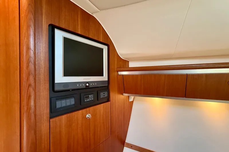 Slide: The Image of Interior of 2006 Tiara Yachts 3600 Sovran with built-in TV and wooden cabinetry. - 24