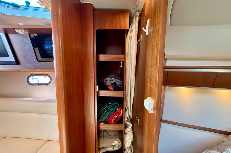 Slide: The Image of Interior of 2006 Tiara Yachts 3600 Sovran showing wooden storage shelves with blankets. - 26