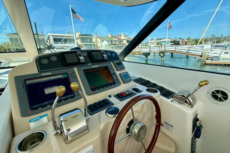 Slide: The Image of Helm of 2006 Tiara Yachts 3600 Sovran with navigation equipment and marina view. - 29