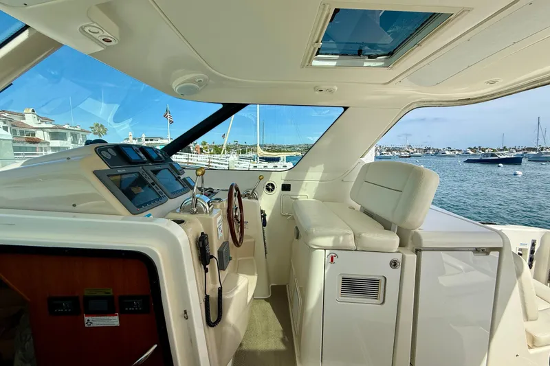 Slide: The Image of 2006 Tiara Yachts 3600 Sovran helm with luxurious seating and marina view. - 30