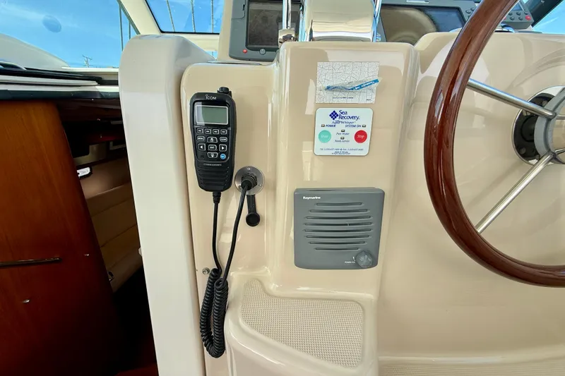 Slide: The Image of 2006 Tiara Yachts 3600 Sovran helm with radio, steering wheel, and navigation equipment. - 32