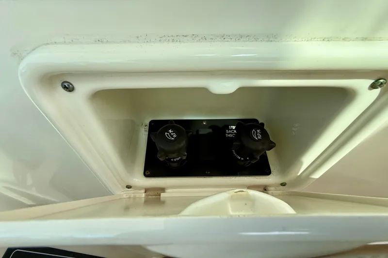 Slide: The Image of Control panel of a 2006 Tiara Yachts 3600 Sovran, featuring RPM and throttle knobs. - 34