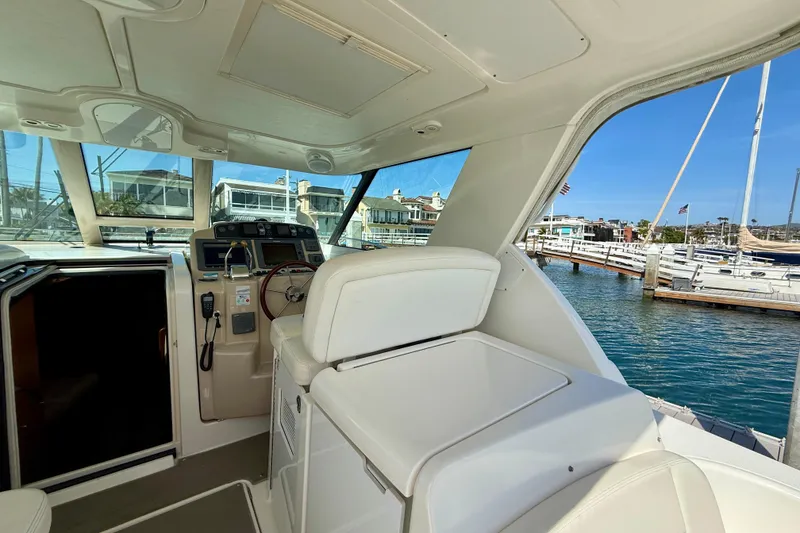 Slide: The Image of Interior view of 2006 Tiara Yachts 3600 Sovran at marina, showcasing helm and seating area. - 35