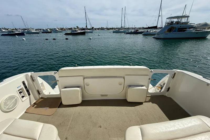 Slide: The Image of 2006 Tiara Yachts 3600 Sovran cockpit view, overlooking a serene marina with multiple boats. - 39