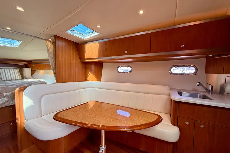 Slide: The Image of Luxurious interior of 2006 Tiara Yachts 3600 Sovran with elegant seating and wood finishes. - 4