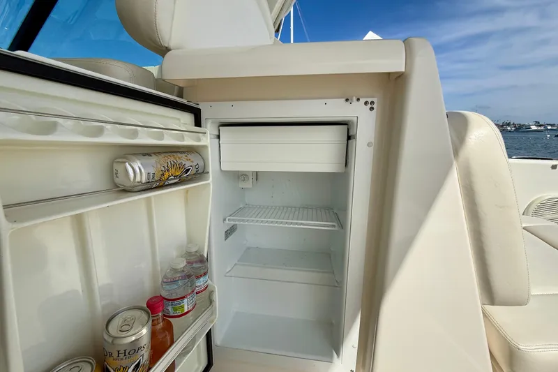 Slide: The Image of Mini fridge on 2006 Tiara Yachts 3600 Sovran, stocked with drinks, open to ocean view. - 40