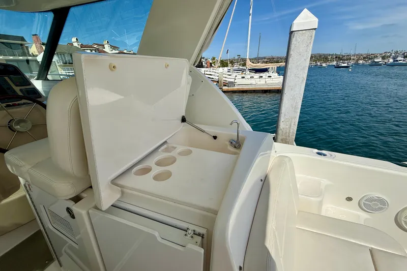 Slide: The Image of 2006 Tiara Yachts 3600 Sovran interior with sink and cup holders, docked at marina. - 41