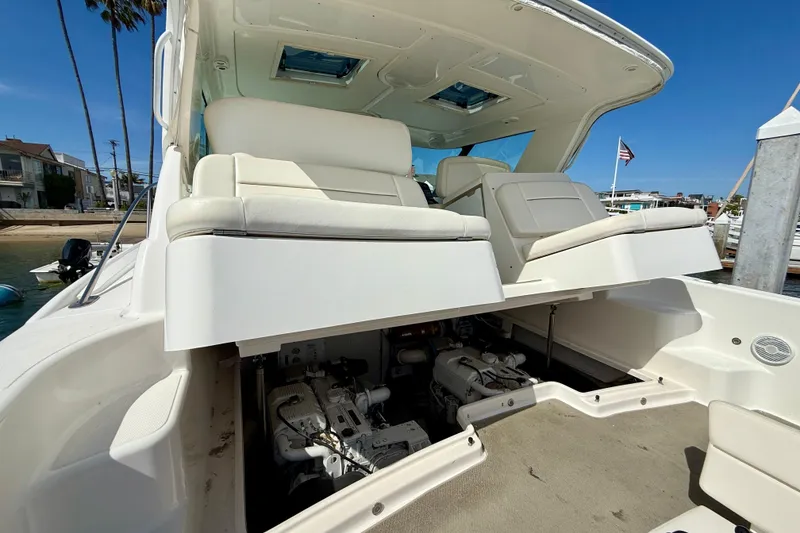Slide: The Image of 2006 Tiara Yachts 3600 Sovran with open engine compartment, docked near palm trees. - 43