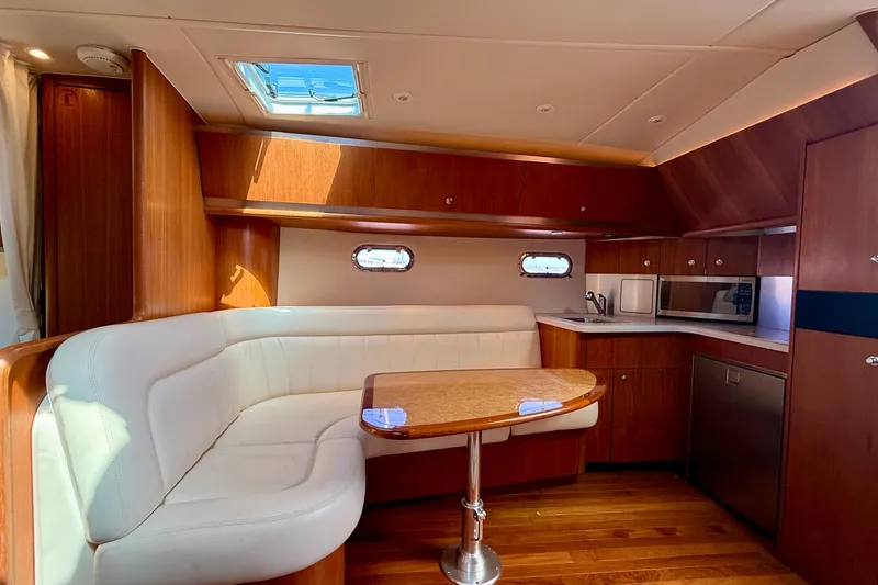 Slide: The Image of Luxurious interior of 2006 Tiara Yachts 3600 Sovran with elegant wood finishes and seating. - 5