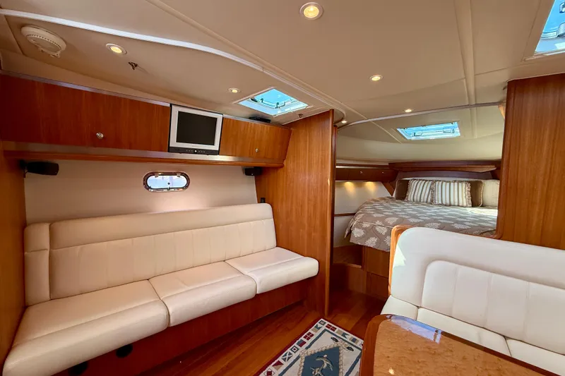 Slide: The Image of Luxurious interior of 2006 Tiara Yachts 3600 Sovran with elegant seating and cozy sleeping area. - 7