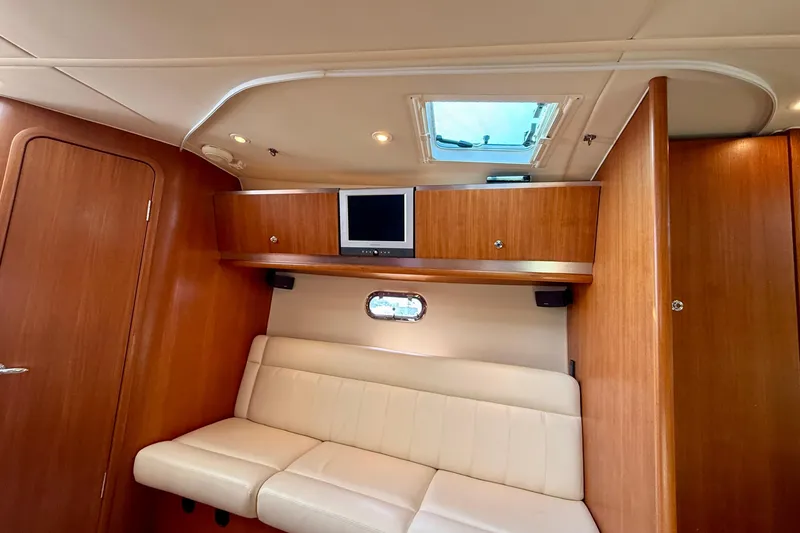 Slide: The Image of Interior of 2006 Tiara Yachts 3600 Sovran with wood paneling and white seating. - 8