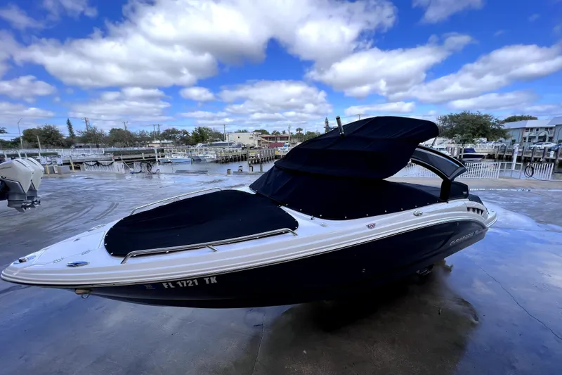 The Image of 2020 Chaparral 237 SSX boat on display at a marina under clear blue skies. - 0