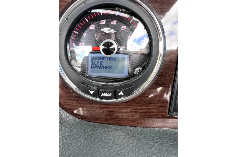 Slide: The Image of 2020 Chaparral 237 SSX boat interior with white seating, docked near a garage. - 12