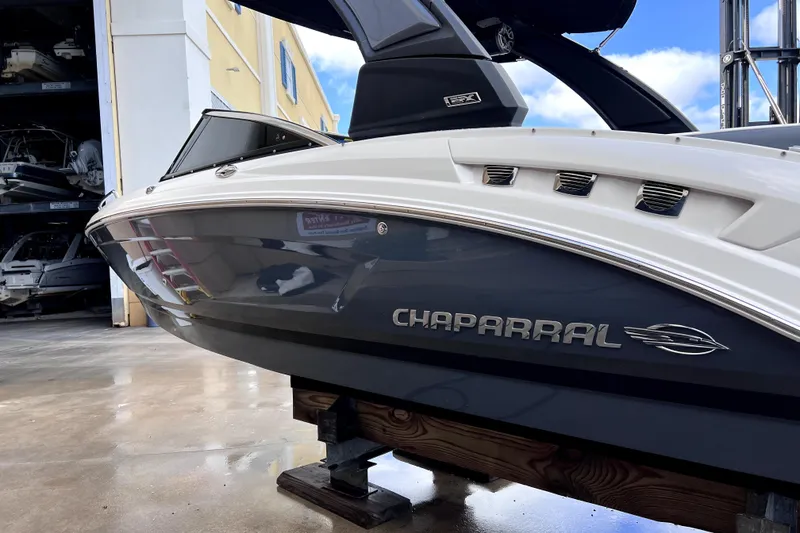 Slide: The Image of 2020 Chaparral 237 SSX boat, rear view, docked on wet pavement. - 2