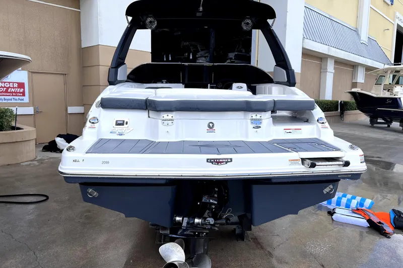 Slide: The Image of 2020 Chaparral 237 SSX boat rear view at dock with ladder. - 3