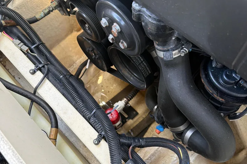 Slide: The Image of Engine compartment of 2020 Chaparral 237 SSX boat, showcasing hoses and wiring. - 31