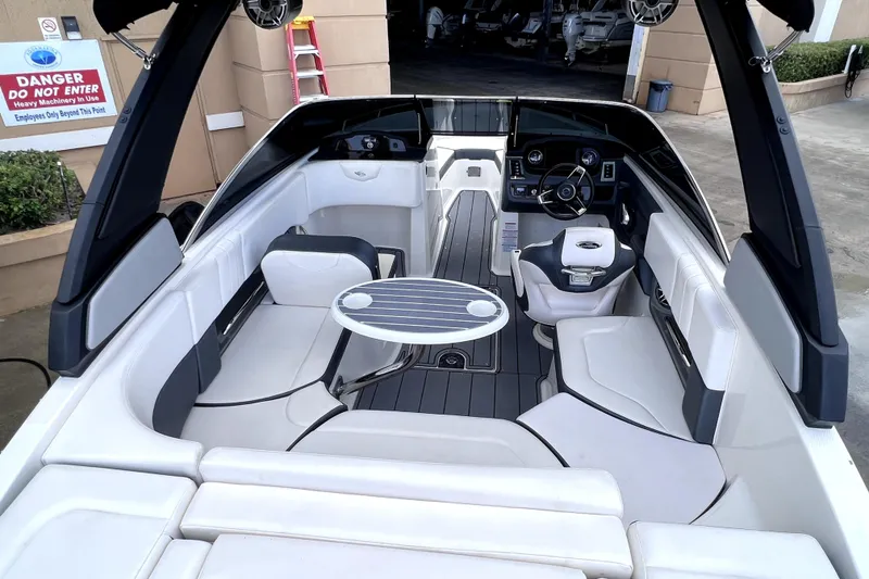 Slide: The Image of 2020 Chaparral 237 SSX boat displayed outdoors, front view, near a large building. - 6