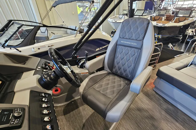 Slide: The Image of 2020 Bennington 23 R Swingback boat interior with steering wheel and captain's chair. - 13