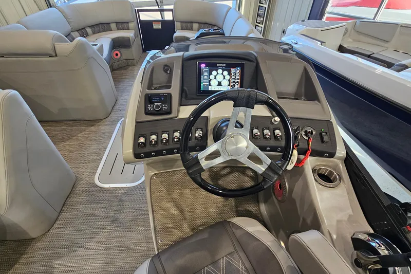 Slide: The Image of Interior view of 2020 Bennington 23 R Swingback boat with steering wheel and control panel. - 14
