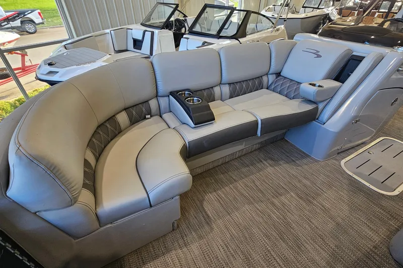 Slide: The Image of Luxurious seating on 2020 Bennington 23 R Swingback pontoon boat, featuring plush upholstery and cup holders. - 16