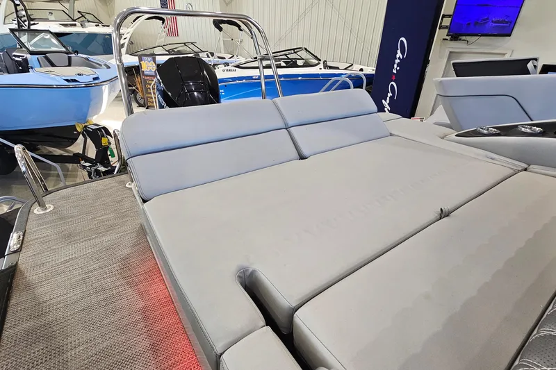 Slide: The Image of 2020 Bennington 23 R Swingback boat interior with gray seating in showroom. - 9