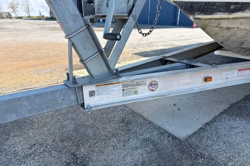 Slide: The Image of Trailer hitch of a 1996 Sea Ray 240 Sundancer boat on pavement. - 11