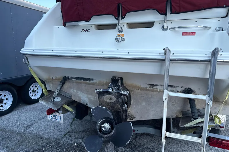 Slide: The Image of 1996 Sea Ray 240 Sundancer boat stern with ladder and propeller visible. - 12