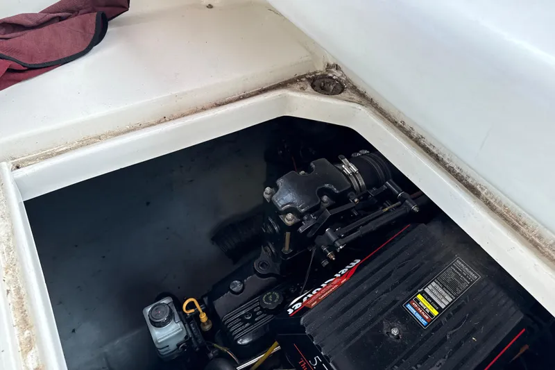 Slide: The Image of Engine compartment of a 1996 Sea Ray 240 Sundancer boat, showcasing mechanical components. - 19
