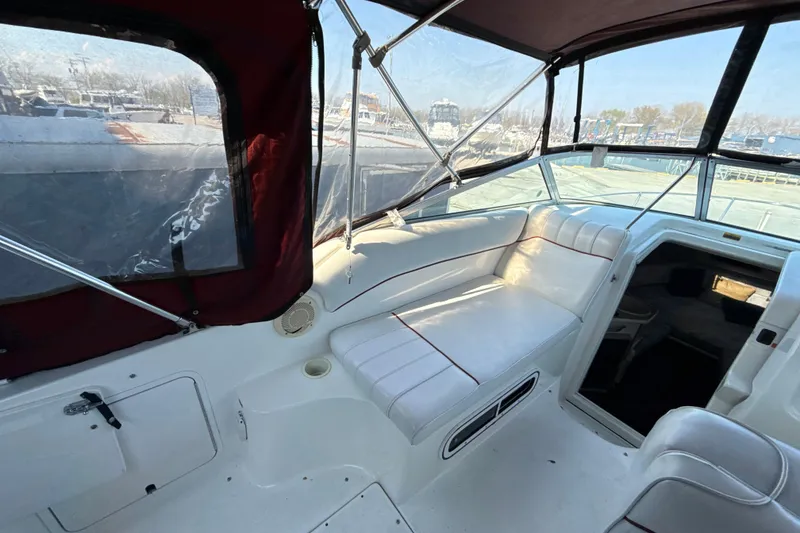 Slide: The Image of Interior view of a 1996 Sea Ray 240 Sundancer boat with white seating and clear canopy. - 27