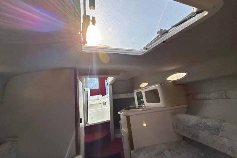 Slide: The Image of Interior of a 1996 Sea Ray 240 Sundancer boat with sunlight through the hatch. - 32
