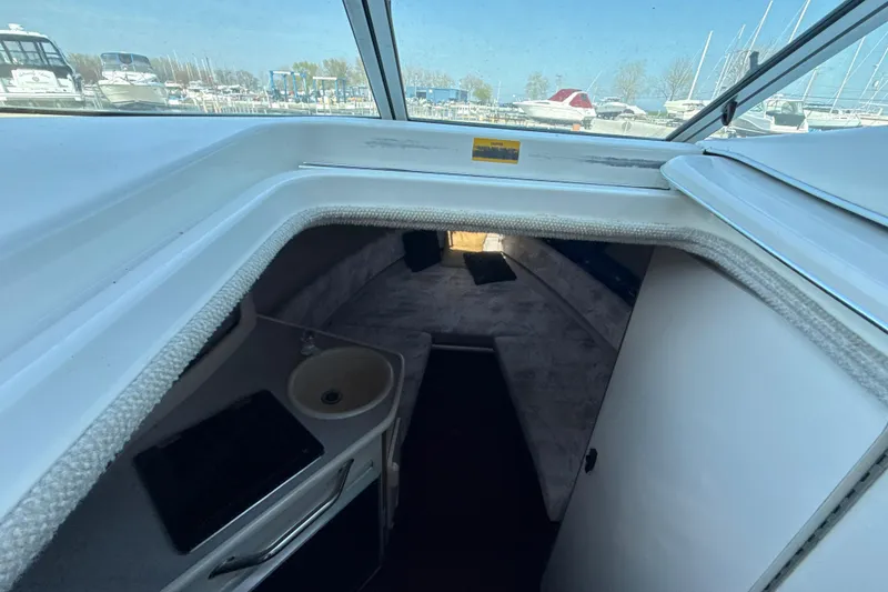 Slide: The Image of Interior cabin of 1996 Sea Ray 240 Sundancer boat with sink and seating area. - 38