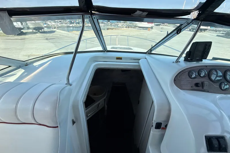 Slide: The Image of 1996 Sea Ray 240 Sundancer boat interior with dashboard and cabin entrance. - 39