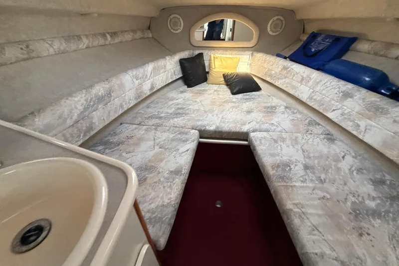 Slide: The Image of Interior cabin of 1996 Sea Ray 240 Sundancer with cushioned seating and sink. - 40
