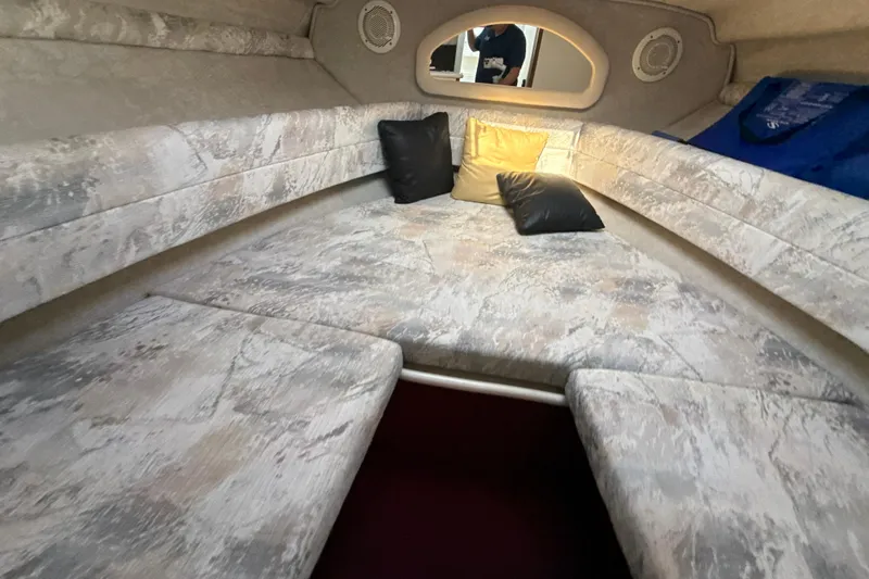 Slide: The Image of Interior cabin of a 1996 Sea Ray 240 Sundancer with cushions and pillows. - 42