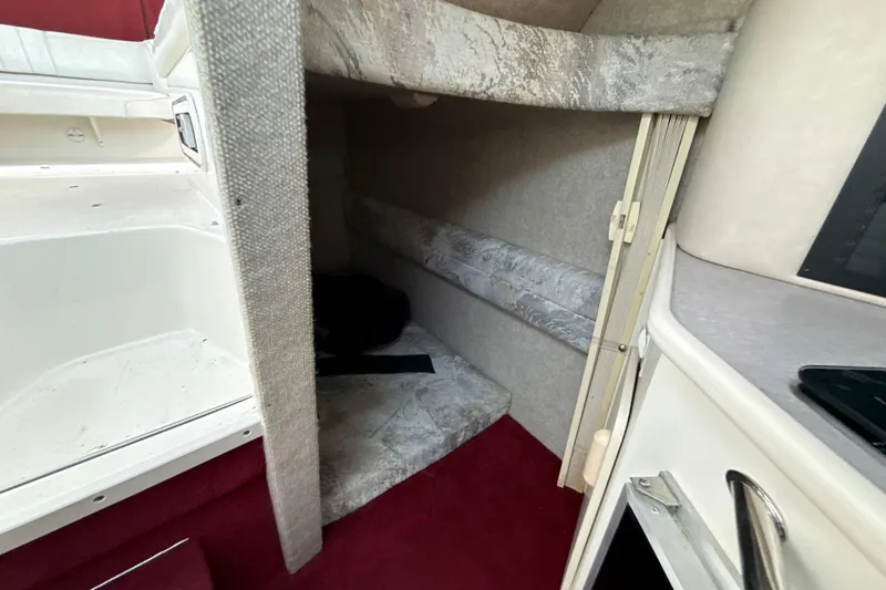 Slide: The Image of Interior cabin of 1996 Sea Ray 240 Sundancer boat with red carpet and seating area. - 43