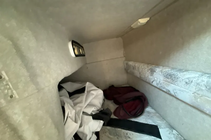 Slide: The Image of Interior cabin of a 1996 Sea Ray 240 Sundancer with storage items. - 46