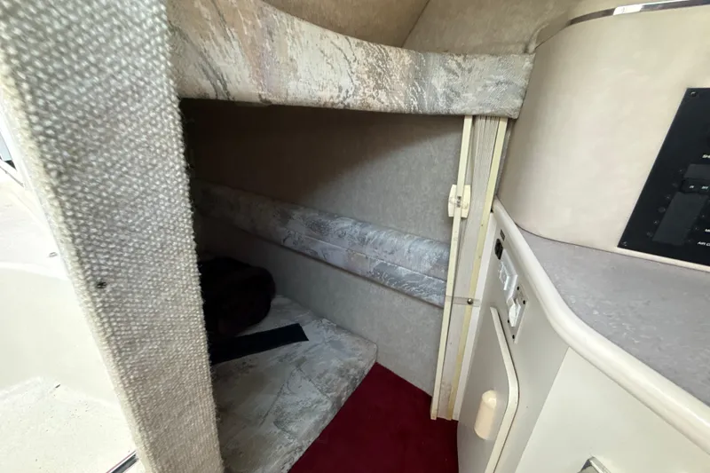 Slide: The Image of Interior cabin of 1996 Sea Ray 240 Sundancer boat, featuring cozy sleeping area. - 47