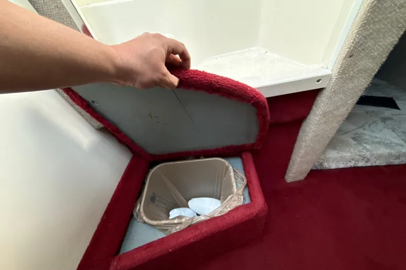 Slide: The Image of Hidden storage compartment on 1996 Sea Ray 240 Sundancer boat with red carpet interior. - 48