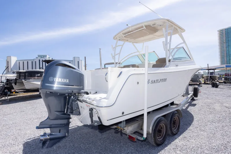 Slide: The Image of 2018 Sailfish 245 DC boat with Yamaha engine on trailer, parked outdoors. - 12