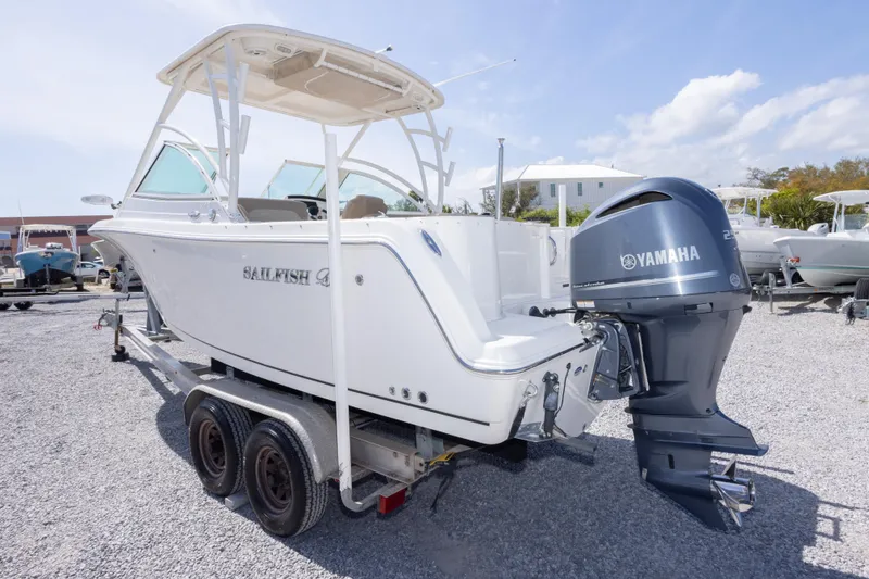 Slide: The Image of 2018 Sailfish 245 DC boat with Yamaha engine on trailer, parked outdoors. - 13