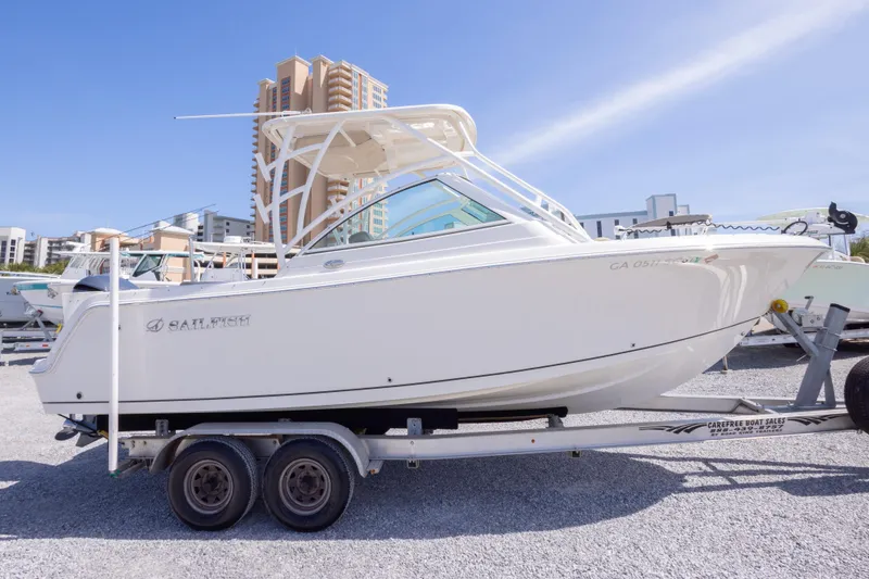 Slide: The Image of 2018 Sailfish 245 DC boat on trailer, urban background, sunny day. - 2