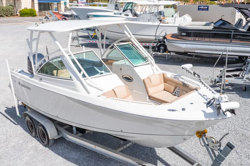 Slide: The Image of 2018 Sailfish 245 DC boat on trailer, featuring sleek design and spacious seating. - 3