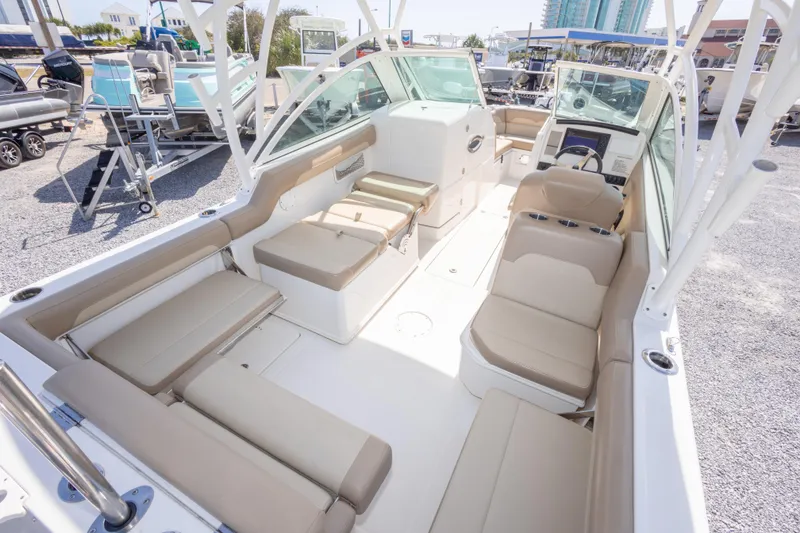 Slide: The Image of 2018 Sailfish 245 DC boat interior with beige seating and modern dashboard. - 38