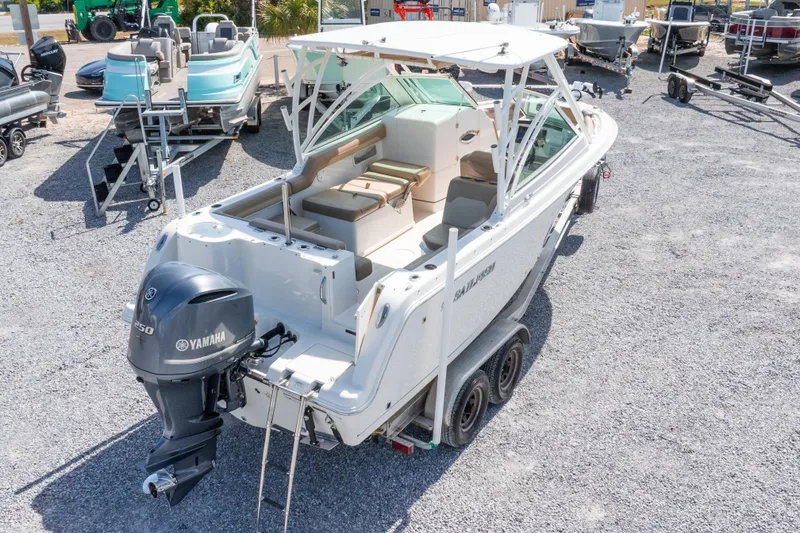Slide: The Image of 2018 Sailfish 245 DC boat with Yamaha engine on trailer in a marina. - 40