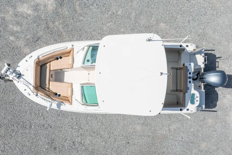 Slide: The Image of Overhead view of 2018 Sailfish 245 DC boat with beige seating and outboard motor. - 9